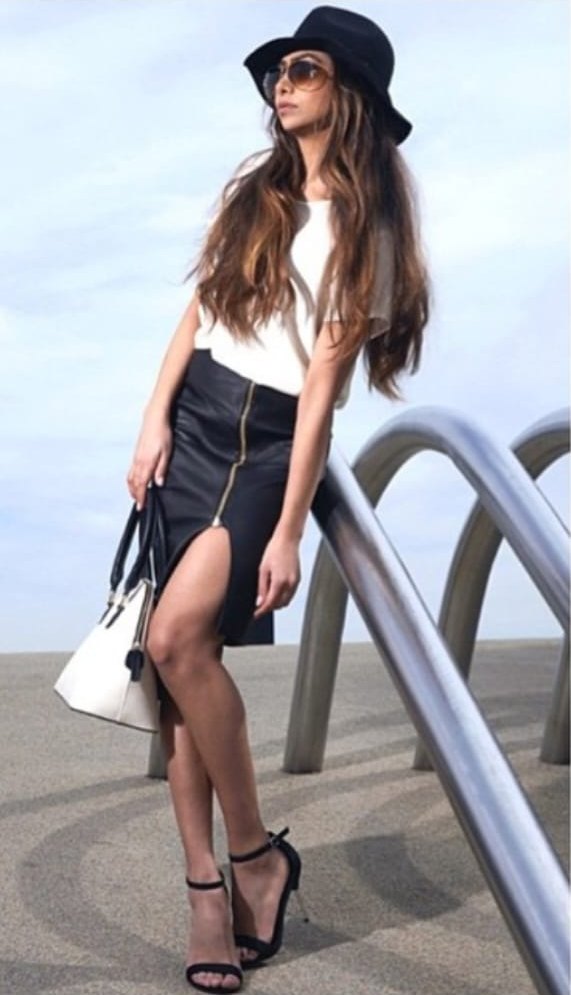Model Aysha Mirza in a black fedora and leather skirt for Anjé New York